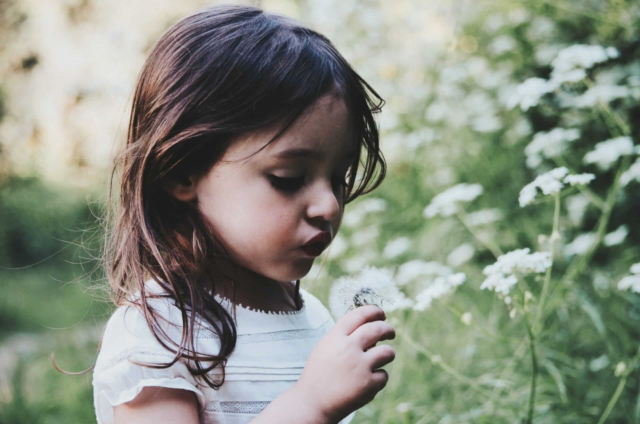 petite fille qui cueille une fleur